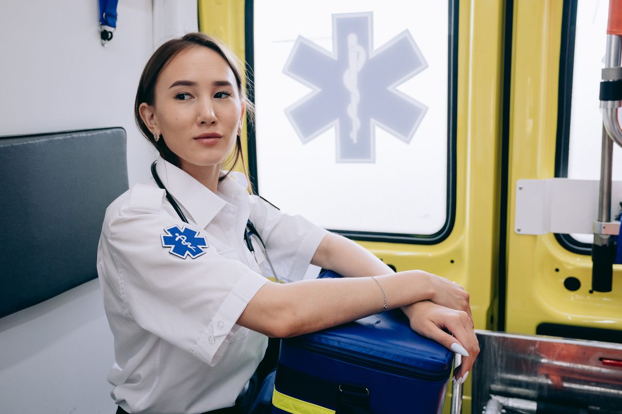 journey Asian woman paramedic inside an ambulance ready for emergency response.