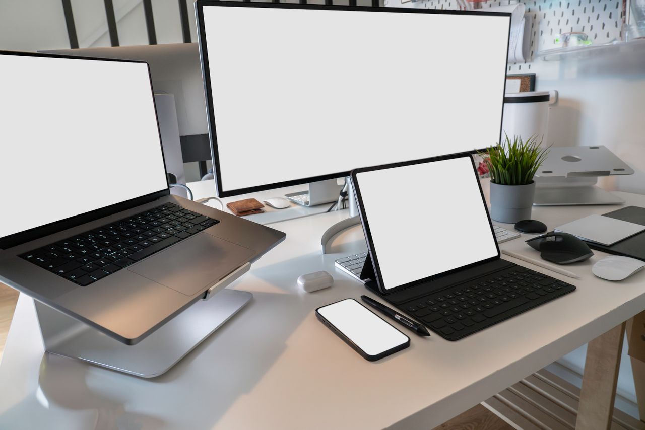 services-03 A clean and modern workspace featuring a laptop, tablet, smartphone, and monitor. Ideal for remote work and tech setups.